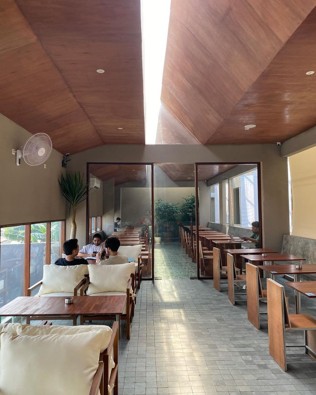 Barista preparing coffee with natural light hitting the counter